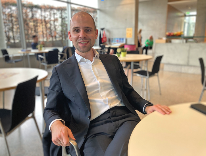 Ein Mann im Anzug sitzt an einem Tisch